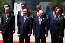 المستفيدون الجدد من اليمين الرئيس الصيني، فالرئيس الروسي، ويظهر في اليسار الرئيس التركي، وبجانبه رئيس فيتنام